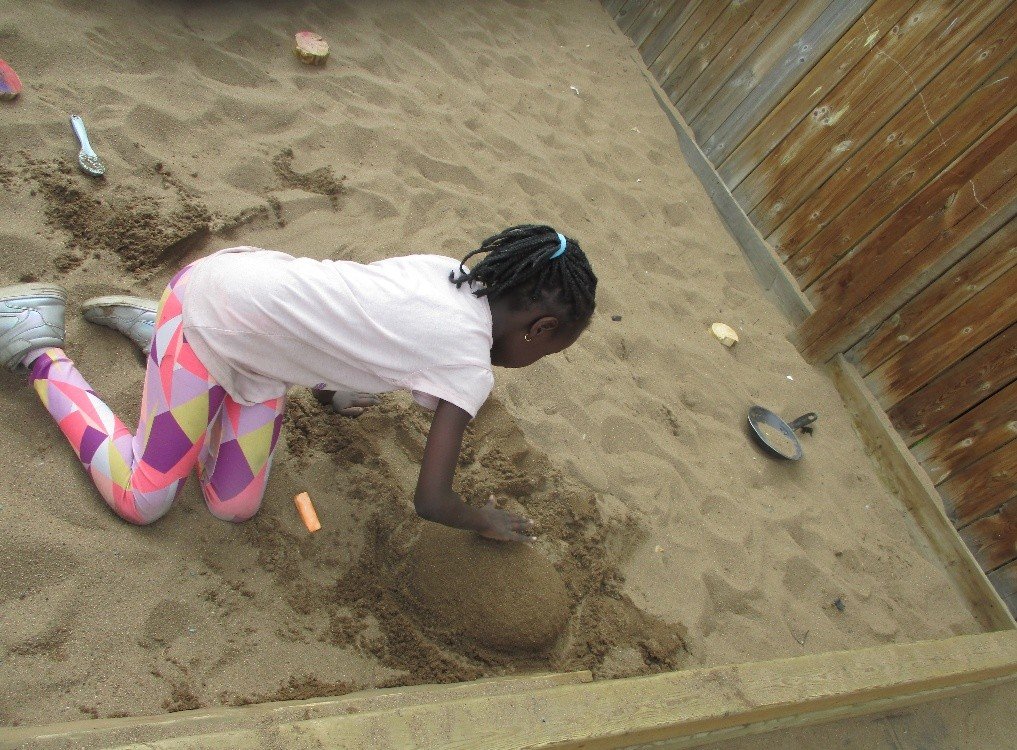 Child building in sand